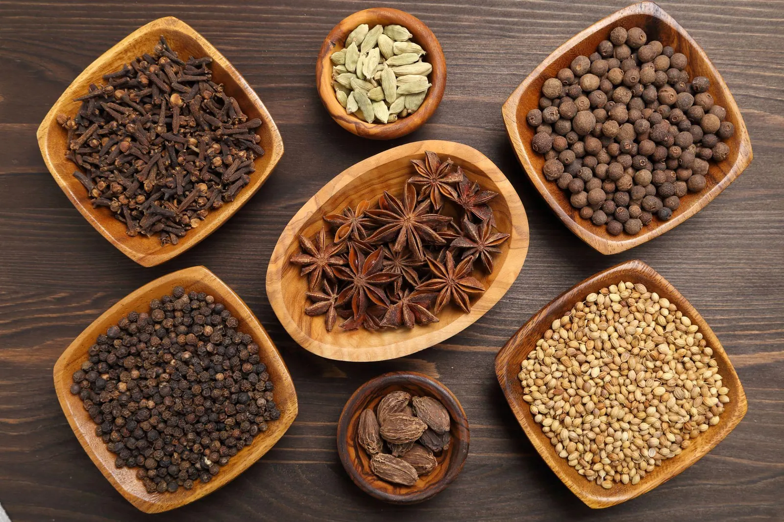 Spices on a dark rustic surface.